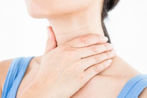 Brunette with throat pain on white background